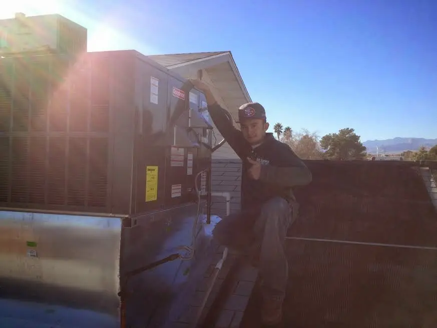 HVAC technician performing Heat Pump Repair on a rooftop unit in Ardmore